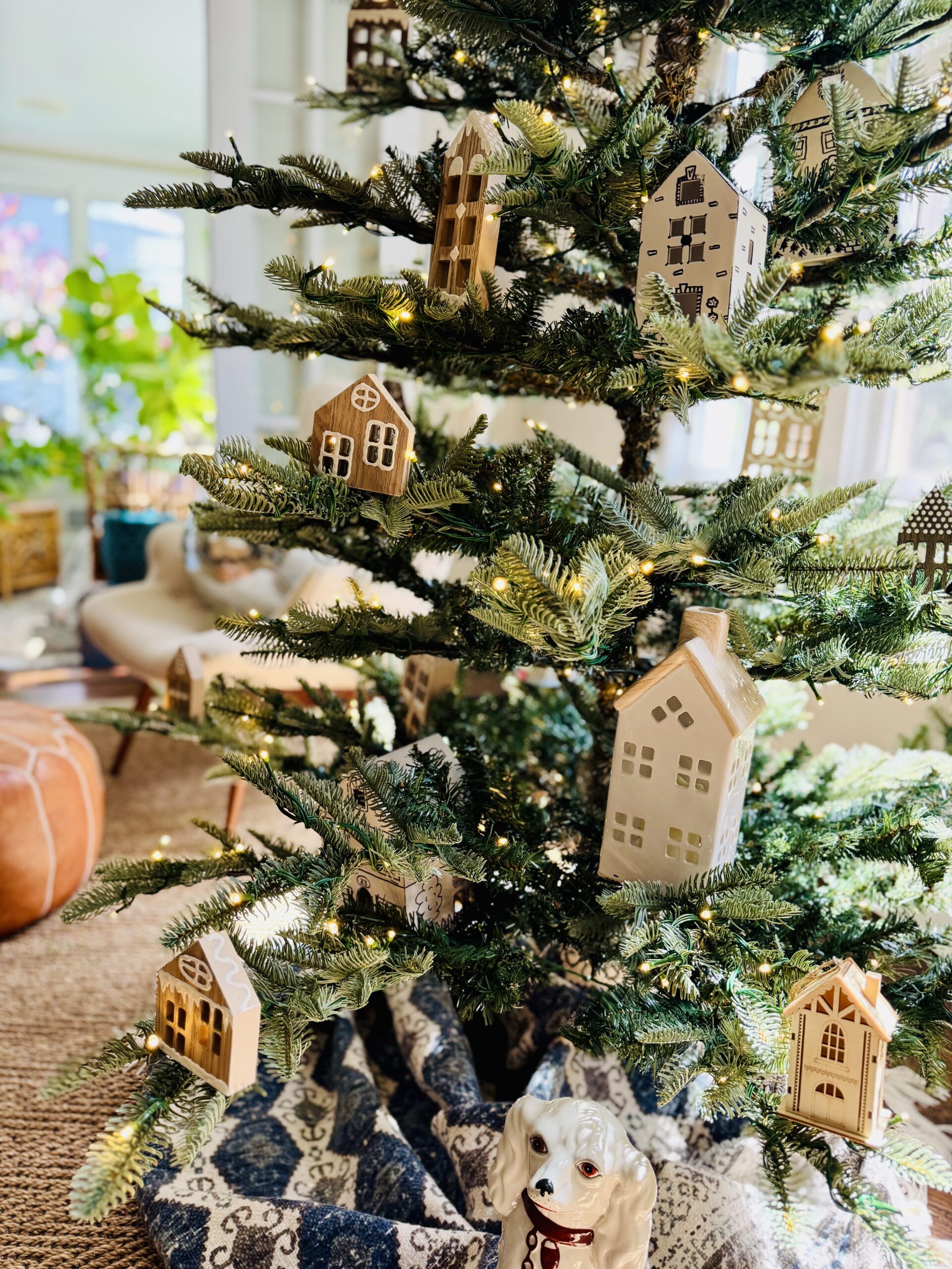 Wood and Ceramic Christmas Houses as Ornaments on Sparse Christmas Tree / kellyelko.com